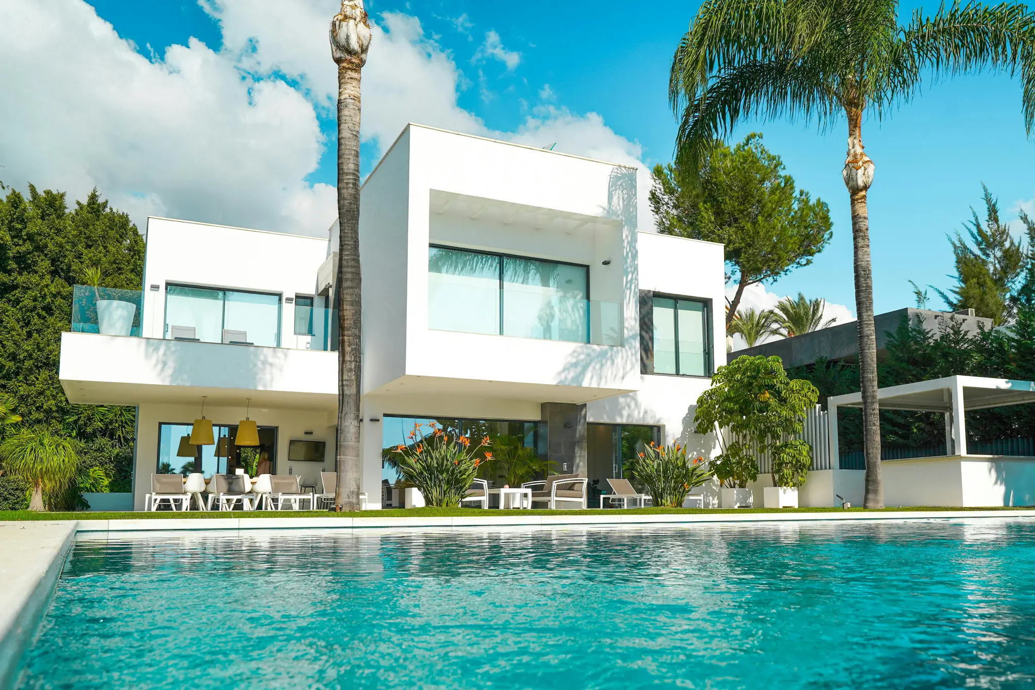Modern Luxury Villa with Pool in Sunlit Garden. Photo by Joachim Hoholm