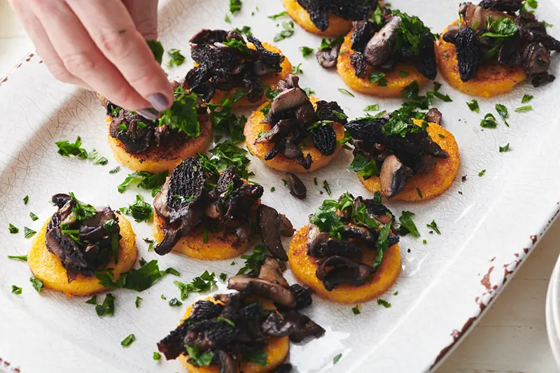 This image shows a recipe for pan fried polenta with sauteed mushrooms. (Cheyenne M. Cohen via AP)