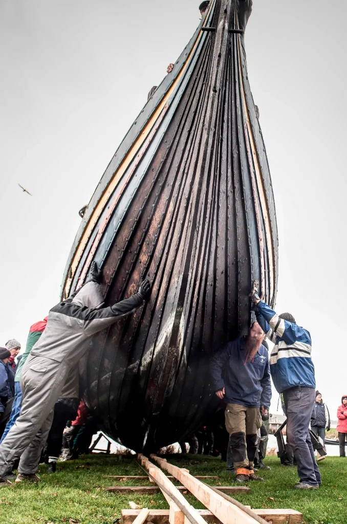 People work to move the Viking ship "Havhingsten fra Glendalough" (The Sea stallion from Glendalough) in order to put it back on water for the winter on October 27, 2018 in Roskilde, Denmark. (Photo credit MADS CLAUS RASMUSSEN/AFP via Getty Images)
